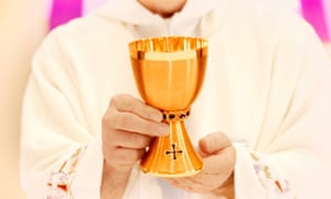 Priest holds communion cup