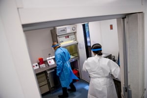 Dr. Justin Jacob, left, and Medical Technologist Sosina Merid, right, with the D.C. Department of Forensic Sciences stand inside in a mobile testing lab unit that will begin accepting testing in response to the Coronavirus outbreak, Tuesday, April 28, 2020, in Washington. A team of technicians can test up to 50 samples within four hours and provide same day results.
