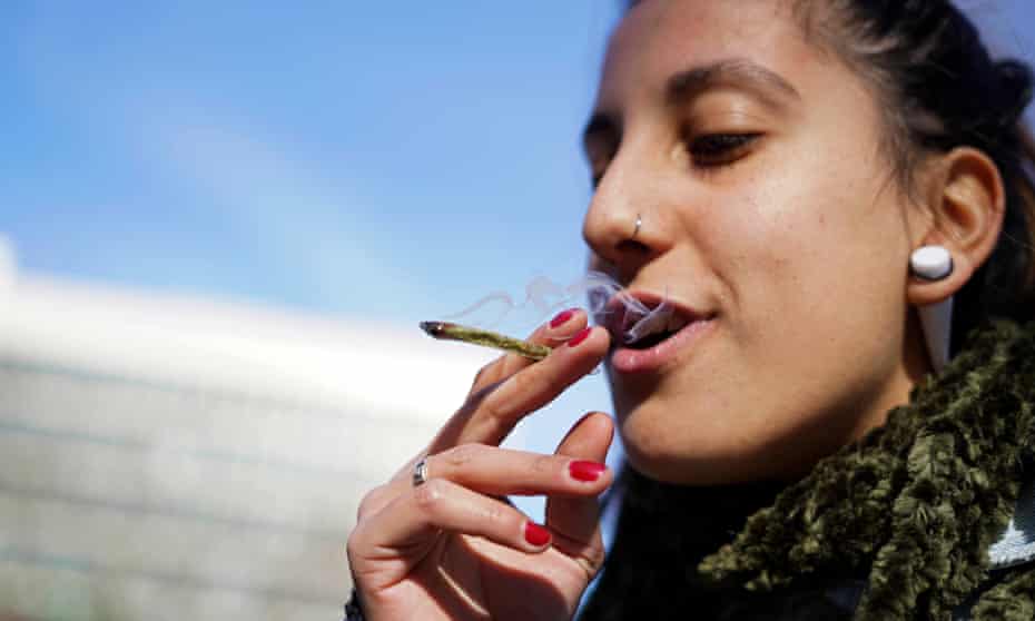 Luisina Mezquita smokes a joint of legal marijuana she bought at a pharmacy in Montevideo, Uruguay.