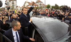 Emmanuel Macron greets supporters as he leaves a polling station in Le Touquet.