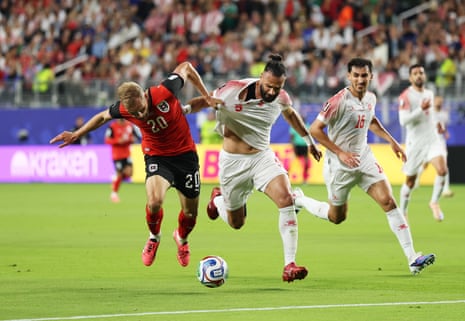 Konrad Laimer of Austria and Yazan Alarab of Jordan compete for the ball