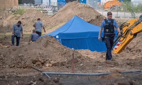 A policeman walks past a blue tent covering a British bomb found during construction works in Frankfurt.