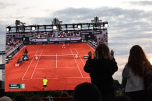A fan reacts as they watch the men’s singles quarter-final between Novak Djokovic and Alexander Zverev on a large screen on the first day of the Roland Garros fan zone at Place de la Concorde
