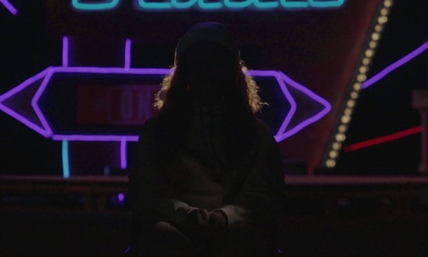 Silhouette of a woman in front of neon lights