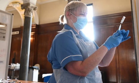 A health worker prepares a dose of the Oxford/AstraZeneca vaccine at a temporary centre in Hull.