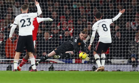 Manchester United’s David de Gea saves from Eddie Nketiah.