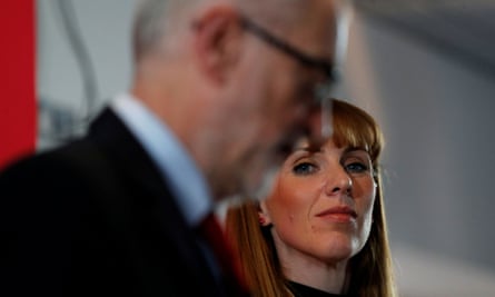 Rayner (in focus) looks at Corbyn, who is in the foreground out of focus