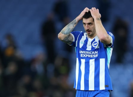 Lewis Dunk puts his hands on his head.