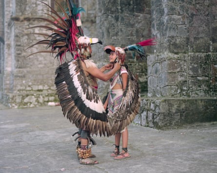 Arturo Díaz helps his daughter Nikté to put on her eagle helmet, Cuetzalan del Progreso
