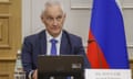 Defence Minister Andrei Belousov speaks during a meeting with a Russian flag to his left