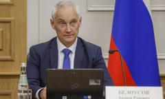 Defence Minister Andrei Belousov speaks during a meeting with a Russian flag to his left