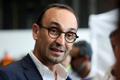 Thomas Cazenave speaks to the media as he visits the Bordeaux-Lac Exhibition Centre, which has been turned into a shelter for people displaced by the wildfire.