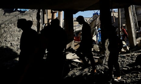 Palestinians inspect the site of an overnight Israeli strike on a house in Rafah.