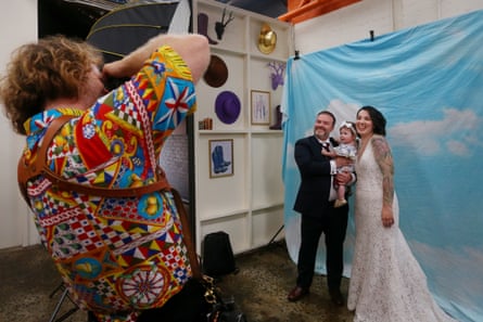 Dane Tucker photographs Amanda Ruffle, John Martin and their daughter after exchanging vows during their wedding ceremony.