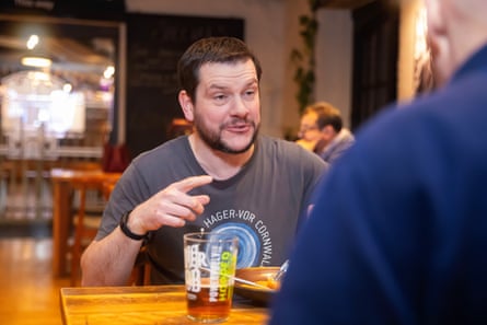 Two men facing each other across a restaurant table