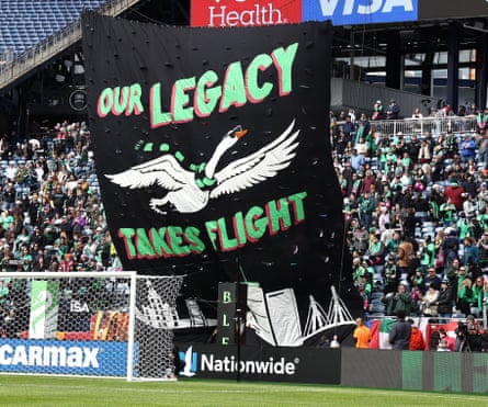 An image of a tifo with the words “Our Legacy Takes Flight” and a swan wearing a soccer scarf.