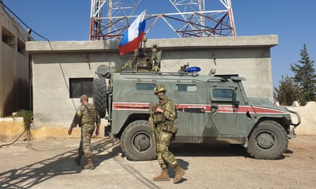 Soldiers with a Russian military police vehicle in Kobane