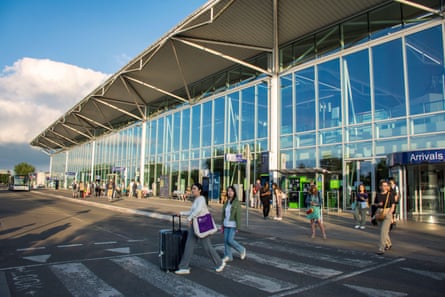 Passengers walk out of the main front entrance of Bristol airport