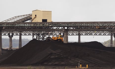 A tractor makes its way over a pile of coal at a coal port in Gladstone, Queensland
