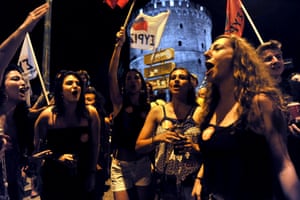 People shout slogans in front of the White Tower, city’s landmark, in Thessaloniki.