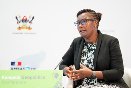 A woman sits and speaks into a microphone.