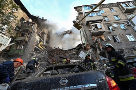 Rescuers work at a site of a residential building heavily damaged by a Russian missile strike in Zaporizhzhia.