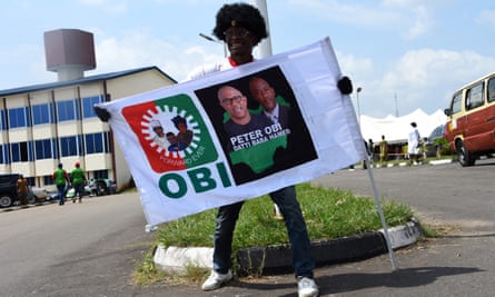 Labour party supporter holds a flag depicting presidential candidate Peter Obi and his running mate Yusuf Datti Baba-Ahmed