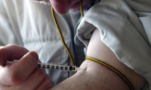 Drug user injecting heroin