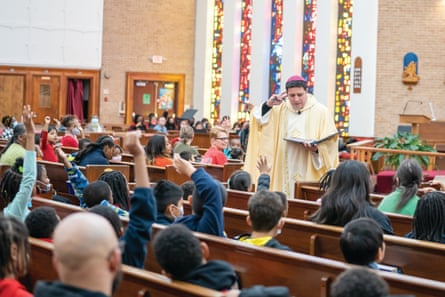 a man in a religious robe stands at the front of a church