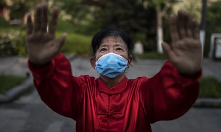A resident wears a mask while practicing shadow boxing in Wuhan