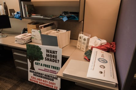 Signs advertising a tree planting program lean against Lora Martens’ desk at the Office of Heat Response and Mitigation.