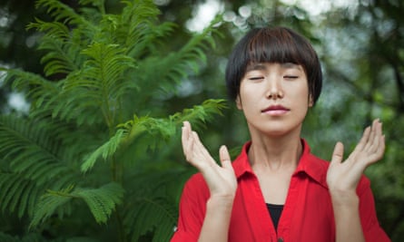 Woman doing deep breathing exercise in nature (posed by model)