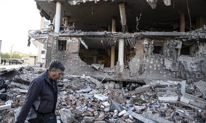 People walk next to a destroyed building hit by Russian missile strike in the Ukrainian city of Kharkiv, Kharkiv Oblast, Ukraine on September 07, 2022.