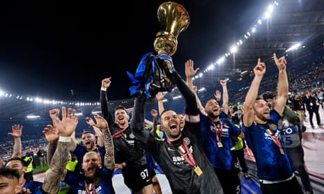 Internazionale’s players celebrate with the trophy after beating Juventus in the Coppa Italia final.