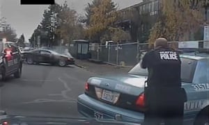 In an image from a dash-cam video on 6 December, a Seattle police officer shoots at a man involved in a high-speed pursuit. The man was killed. The FBI says it will publish a wider range of data on fatal police shootings.