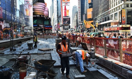 Workers pave a road at Times Square in New York City
