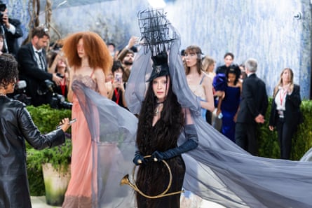 Madonna in gothic black dress with ship-like headpiece and long grey veils