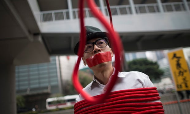 A protester with tape on his mouth stands in front of a noose that reads: ‘Kidnapping’ during a protest on 10 January over the Causeway Bay booksellers’ disappearances.
