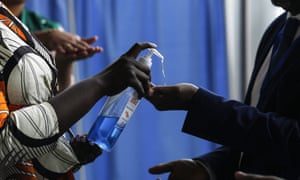 People arriving at the African Union headquarters in Addis Ababa are given disinfectant