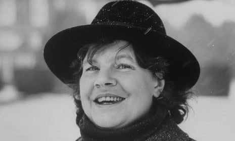 AS Byatt – black and white close-up photo of author in the snow, wearing a black fedora-style hat and scarf, laughing