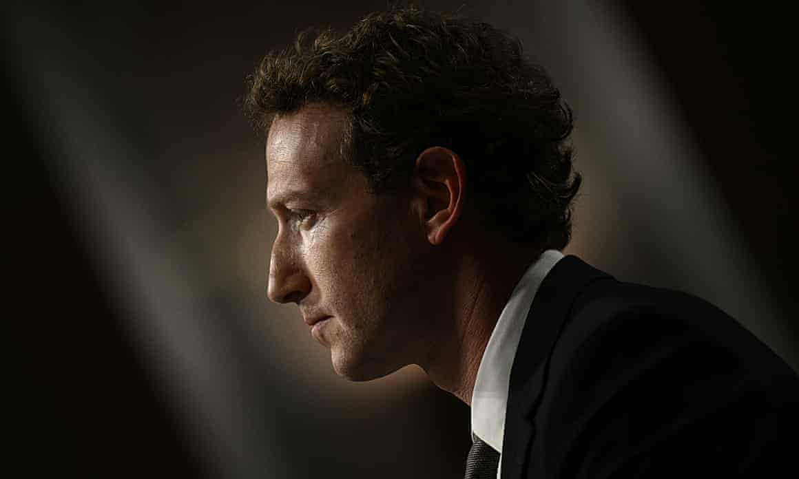 A side profile of Mark Zuckerberg in dark suit, white shirt and dark tie