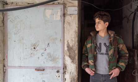 Hamad Shukri poses for a photograph in a basement doorway