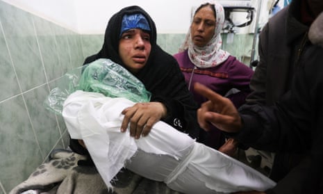 Doaa Abu Lashin holds her daughter, Zeinab Abu Lashin, who was killed in an Israeli strike, at Abu Yousef al-Najjar hospital, in Rafah.
