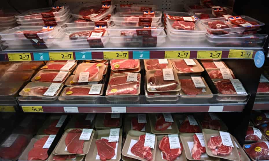 Cheap pork deals advertised on a supermarket shelf