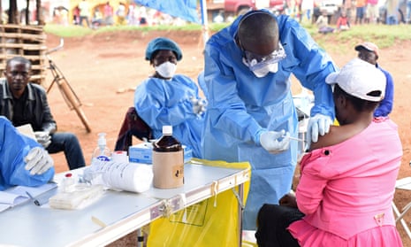 A Congolese health worker administers Ebola vaccine to a woman in North Kivu.