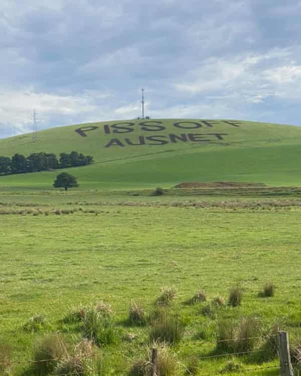 The green, grassy hill facing the Swiss Mountain Hotel in Blampied where someone has mown the words “piss off AusNet’ into the grass