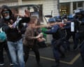 Police officers spray students with pepper spray in Paris.