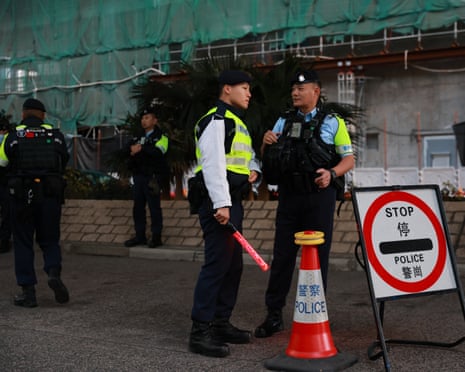 Police outside the West Kowloon law courts in Hong Kong ahead of the high court verdicts