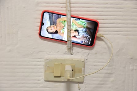 A shattered mobile phone displays a memory from back home.
