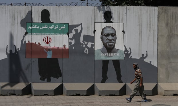 Murals in Kabul depict an Iranian flag showing people drowning with text reading ‘We can’t breathe’ in Persian next to a picture of George Floyd.